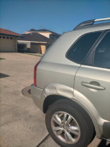 Damaged car panel before repair by a Dent Guy North Brisbane